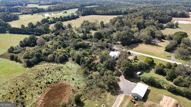 an empty room with a window and a ceiling fan