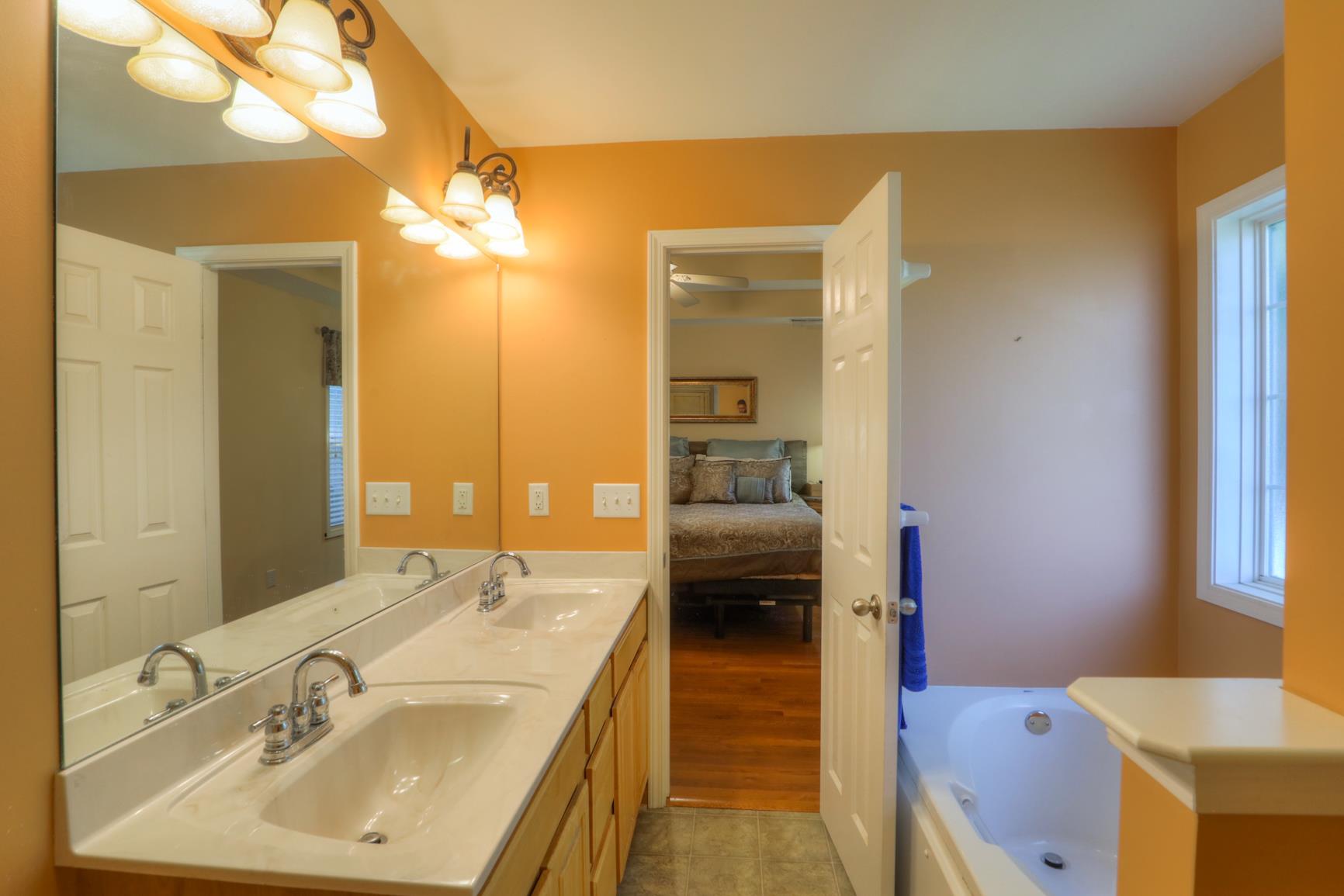 1010 Golf View Way Spring Hill, TN 37174 - Photo 11 of 22 Your master bath features double vanities and a separate shower and soaking tub.