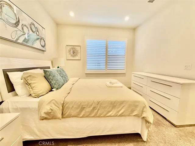 a bed sitting in a bedroom next to a window