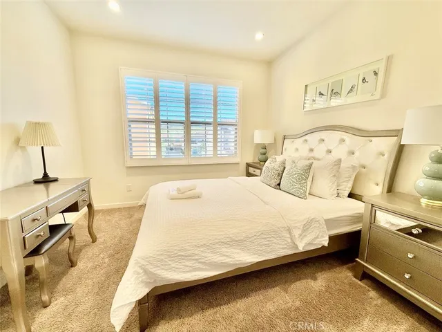 a bedroom with a bed and a night stand