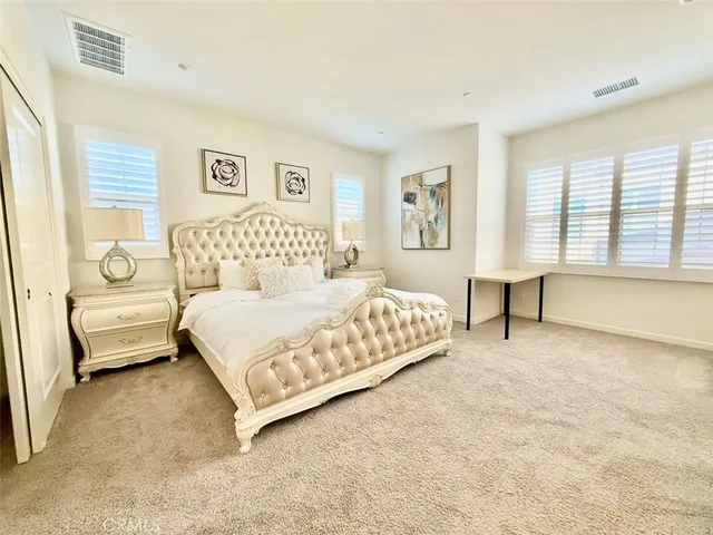 a bedroom with a bed couch and a window