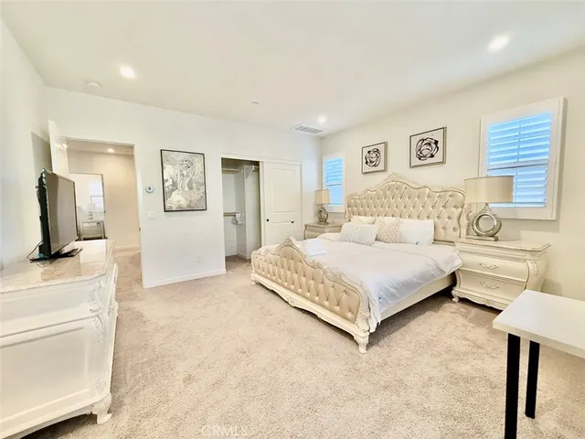 a bedroom with a large bed and a couch