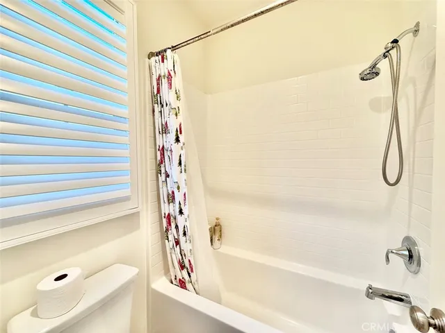 a bathroom with a shower and a bath tub