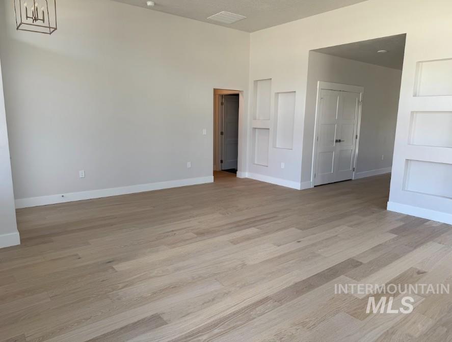665 West Wrangler Street Meridian, ID 83646 - Photo 5 of 18 Spacious interior with light-toned wood-finish flooring, white baseboards, and neutral wall paint