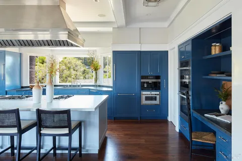a kitchen with a table chairs refrigerator and cabinets