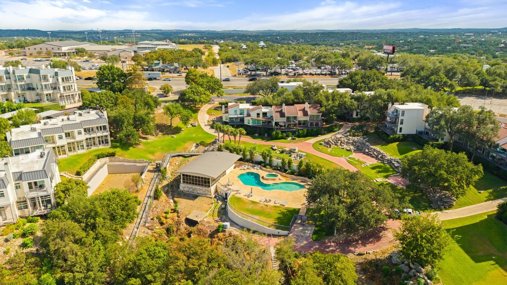 2918 Ranch Road 620 North, Unit 268 Austin, TX 78734 - Photo 39 of 40 Aerial view of the community pool and beautifully landscaped grounds, with mature trees and surrounding neighborhood views.