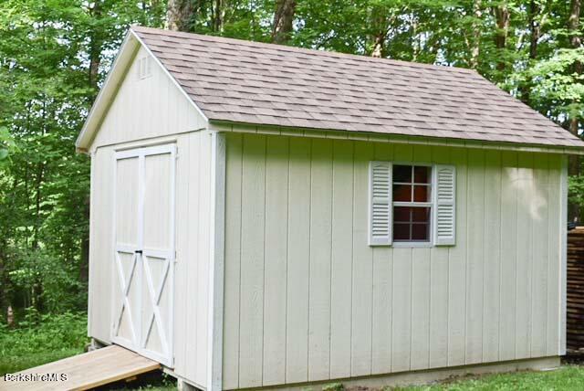488 Summit Road Richmond, MA 01254 - Photo 17 of 44 a view of small house with wooden deck and backyard