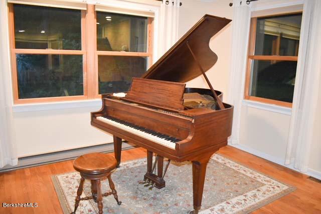 488 Summit Road Richmond, MA 01254 - Photo 25 of 44 a living room with a piano a rug and a window