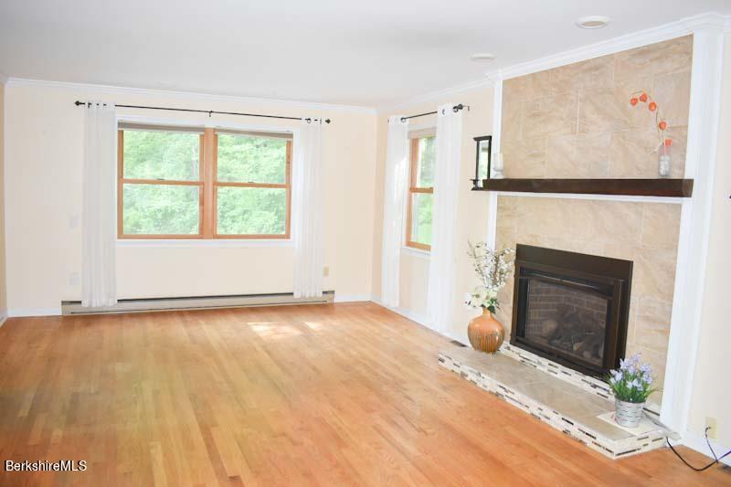 488 Summit Road Richmond, MA 01254 - Photo 26 of 44 a view of an empty room with a fireplace and a window