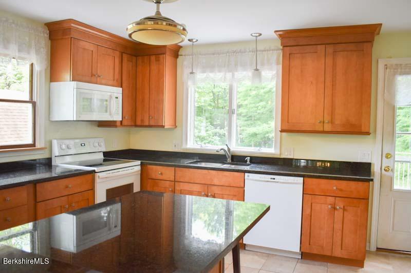 488 Summit Road Richmond, MA 01254 - Photo 28 of 44 a kitchen with stainless steel appliances granite countertop a stove a sink dishwasher and microwave with wooden floor