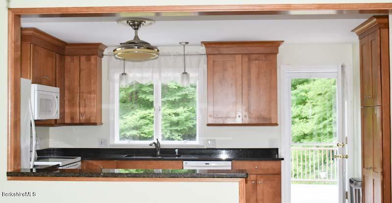 488 Summit Road Richmond, MA 01254 - Photo 29 of 44 a kitchen with a window a sink and cabinets