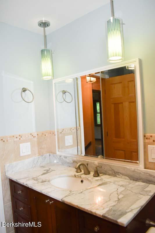 488 Summit Road Richmond, MA 01254 - Photo 34 of 44 a bathroom with a sink and a mirror