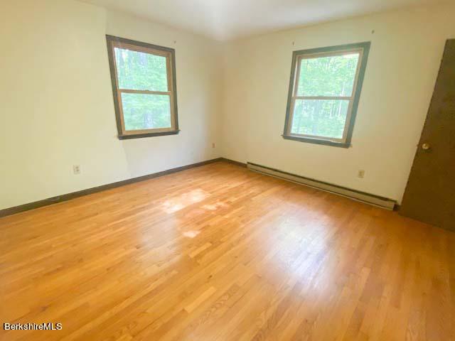 488 Summit Road Richmond, MA 01254 - Photo 40 of 44 a view of an empty room with wooden floor and a window