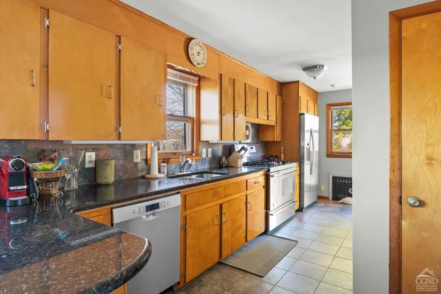 a front view of a house with a garden