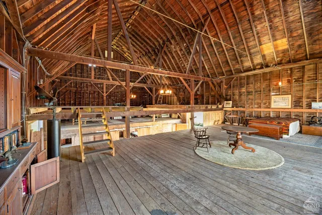 a dining room with furniture and a floor to ceiling window