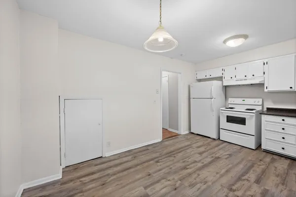 a kitchen with white cabinets and stainless steel appliances