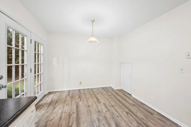 a view of a room with wooden floor and windows