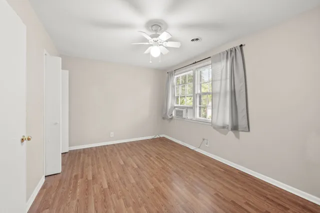 wooden floor in an empty room with a window
