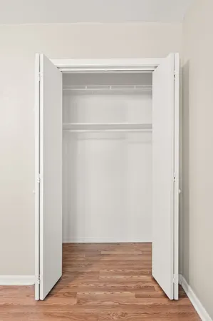 a view of a room with wooden floor