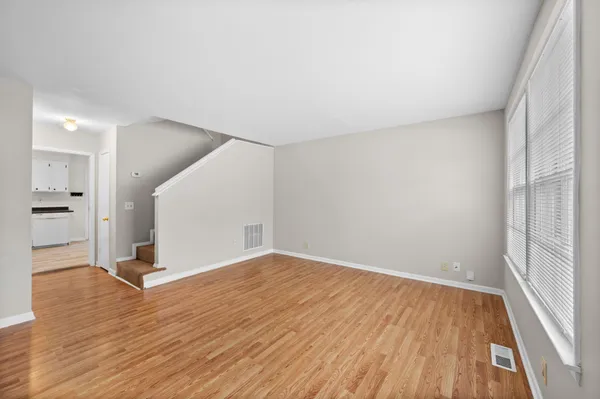 wooden floor in an empty room with a window