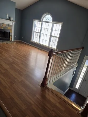 wooden floor in an empty room with a fireplace