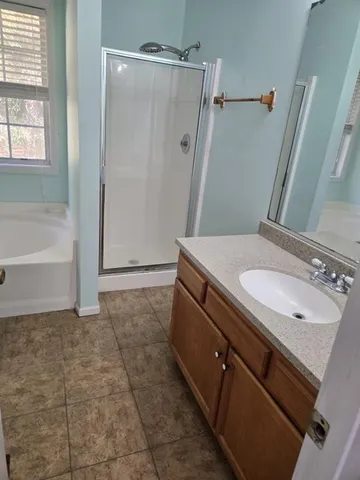 a bathroom with a granite countertop sink a toilet and shower