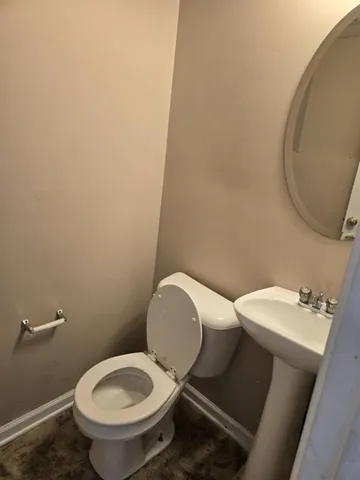 a white toilet sitting next to a bathroom sink
