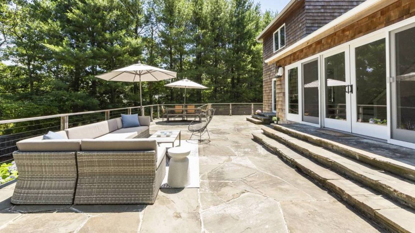 10 Scallop Avenue East Hampton, NY 11937 - Photo 19 of 23 a view of a patio with a table and chairs under an umbrella