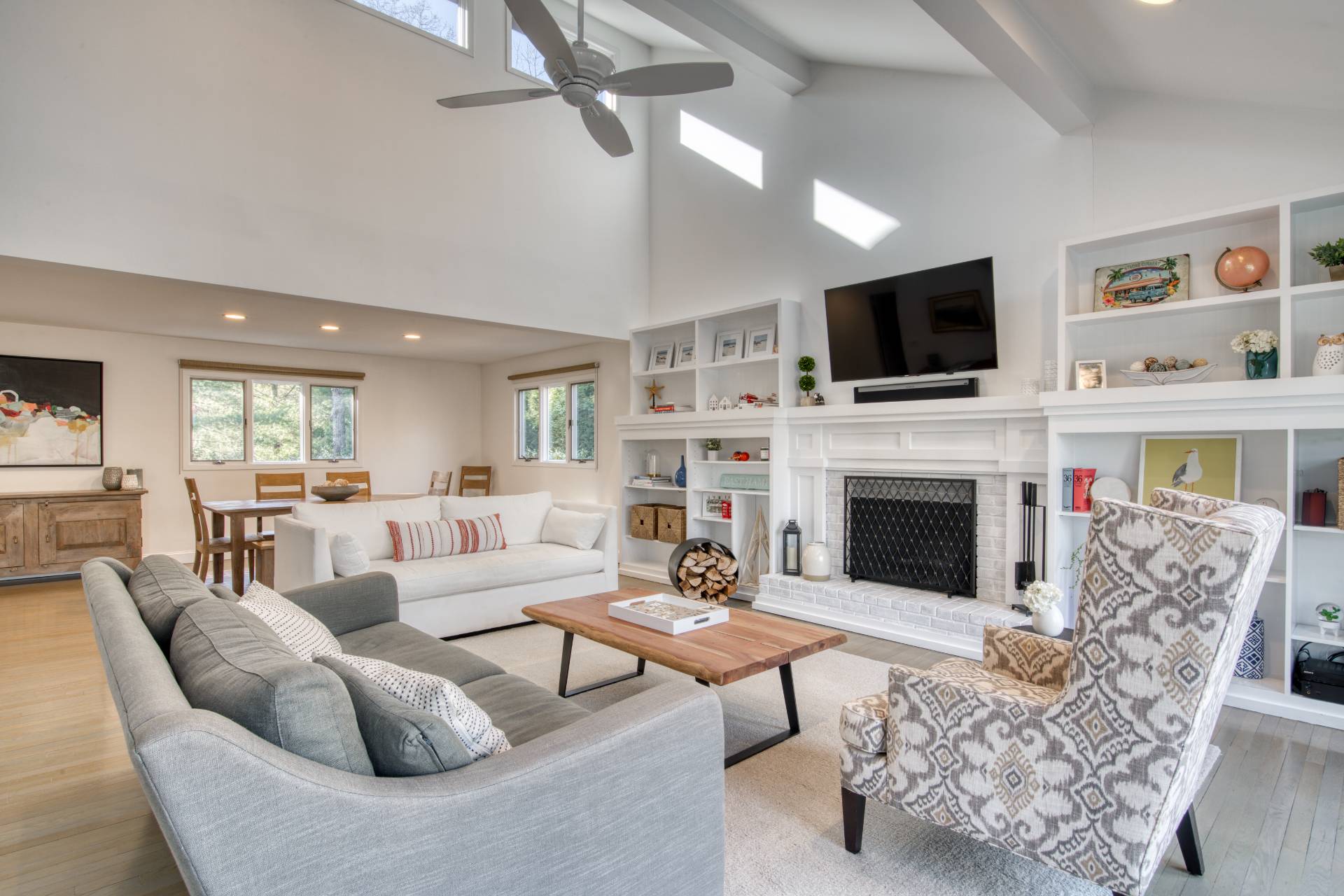 10 Scallop Avenue East Hampton, NY 11937 - Photo 3 of 23 a living room with furniture a fireplace and a flat screen tv