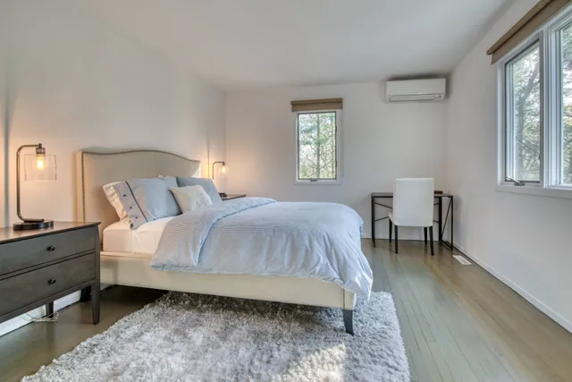 a spacious bedroom with a bed and a window