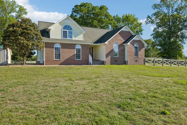 a front view of a house with a yard