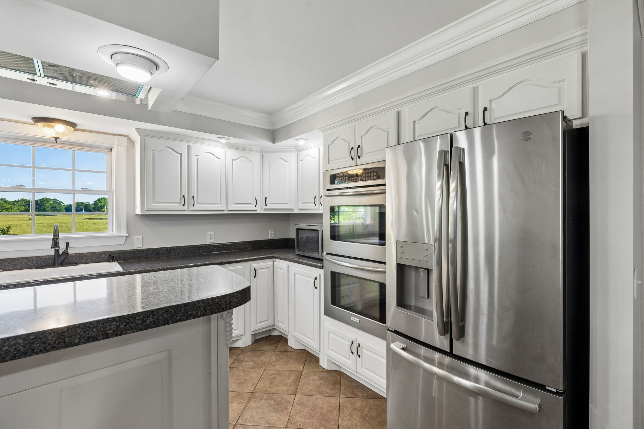100 Heath Road Charlotte, TN 37036 - Photo 16 of 42 a kitchen with granite countertop a refrigerator and a sink