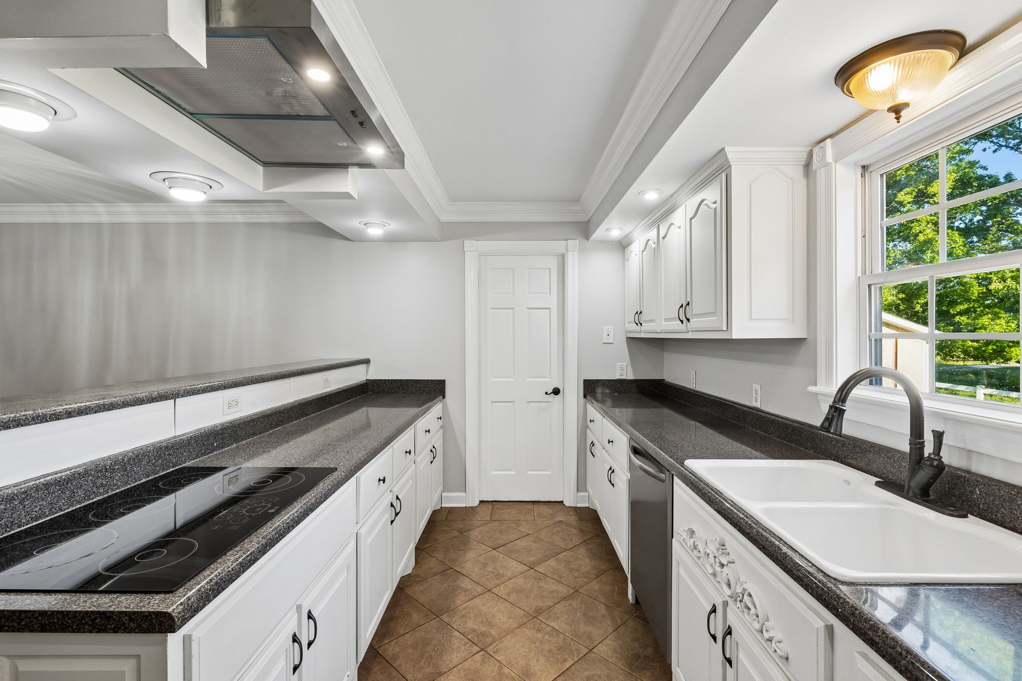 100 Heath Road Charlotte, TN 37036 - Photo 17 of 42 a kitchen with a sink stove and cabinets