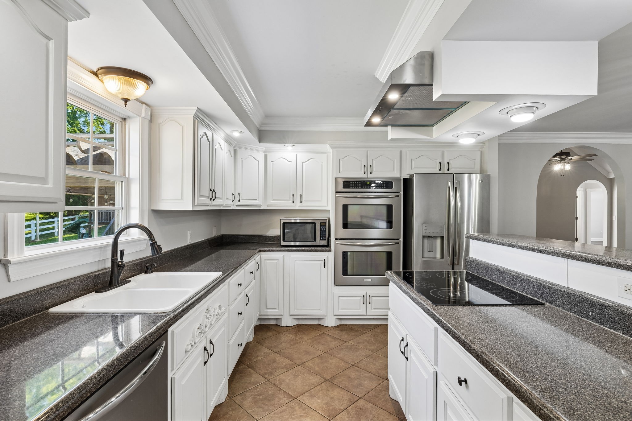 100 Heath Road Charlotte, TN 37036 - Photo 18 of 42 a kitchen with granite countertop a sink stainless steel appliances and cabinets