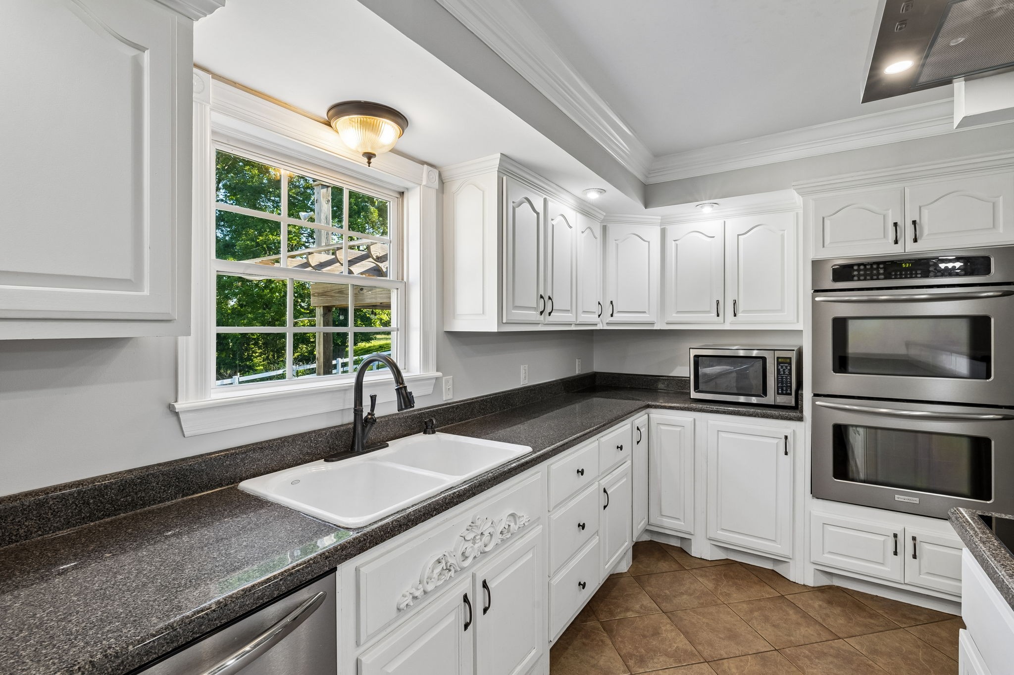 100 Heath Road Charlotte, TN 37036 - Photo 20 of 42 a kitchen with granite countertop a sink stainless steel appliances and cabinets