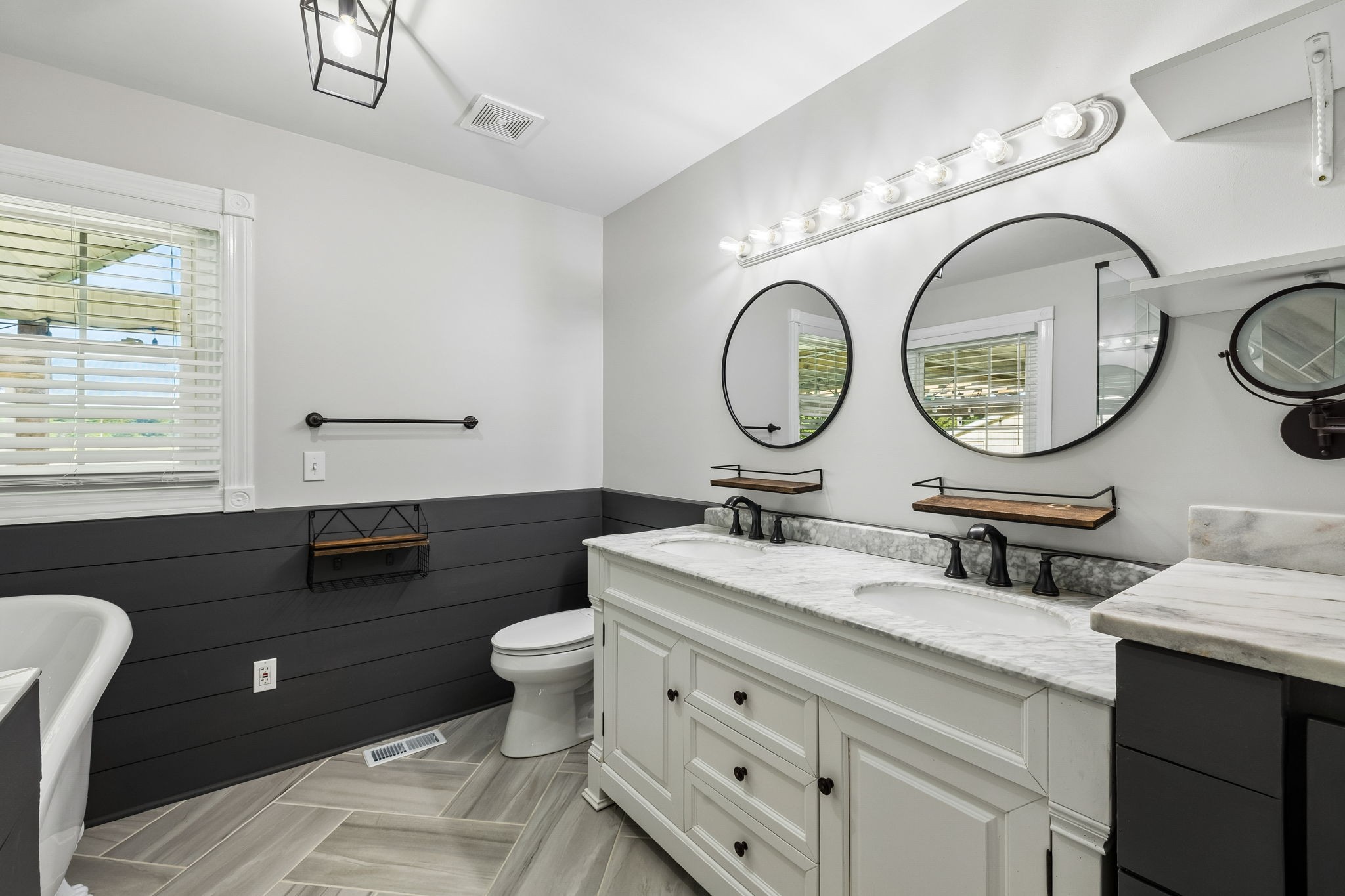 100 Heath Road Charlotte, TN 37036 - Photo 27 of 42 a bathroom with a granite countertop toilet a sink a mirror and a window