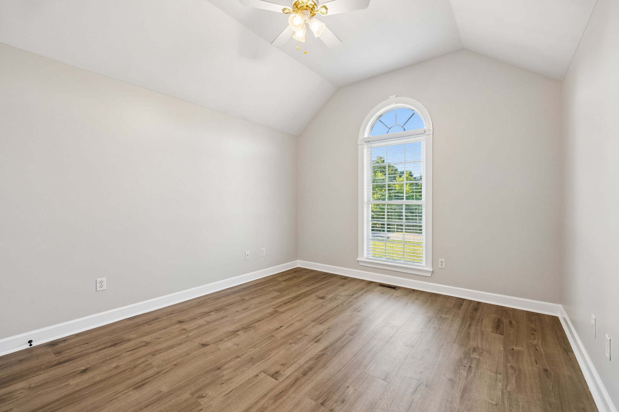 100 Heath Road Charlotte, TN 37036 - Photo 30 of 42 an empty room with wooden floor chandelier fan and windows