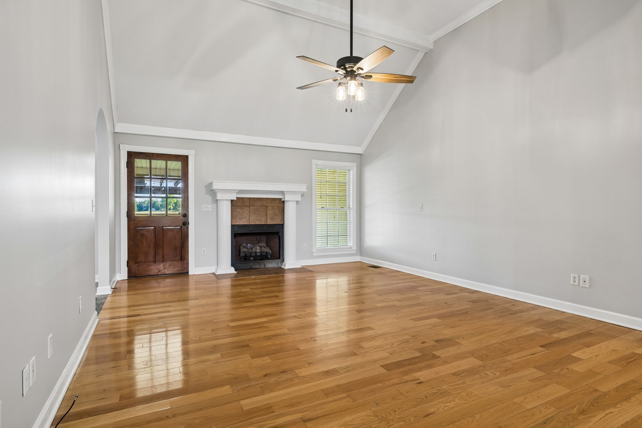 100 Heath Road Charlotte, TN 37036 - Photo 6 of 42 an empty room with wooden floor fireplace and windows