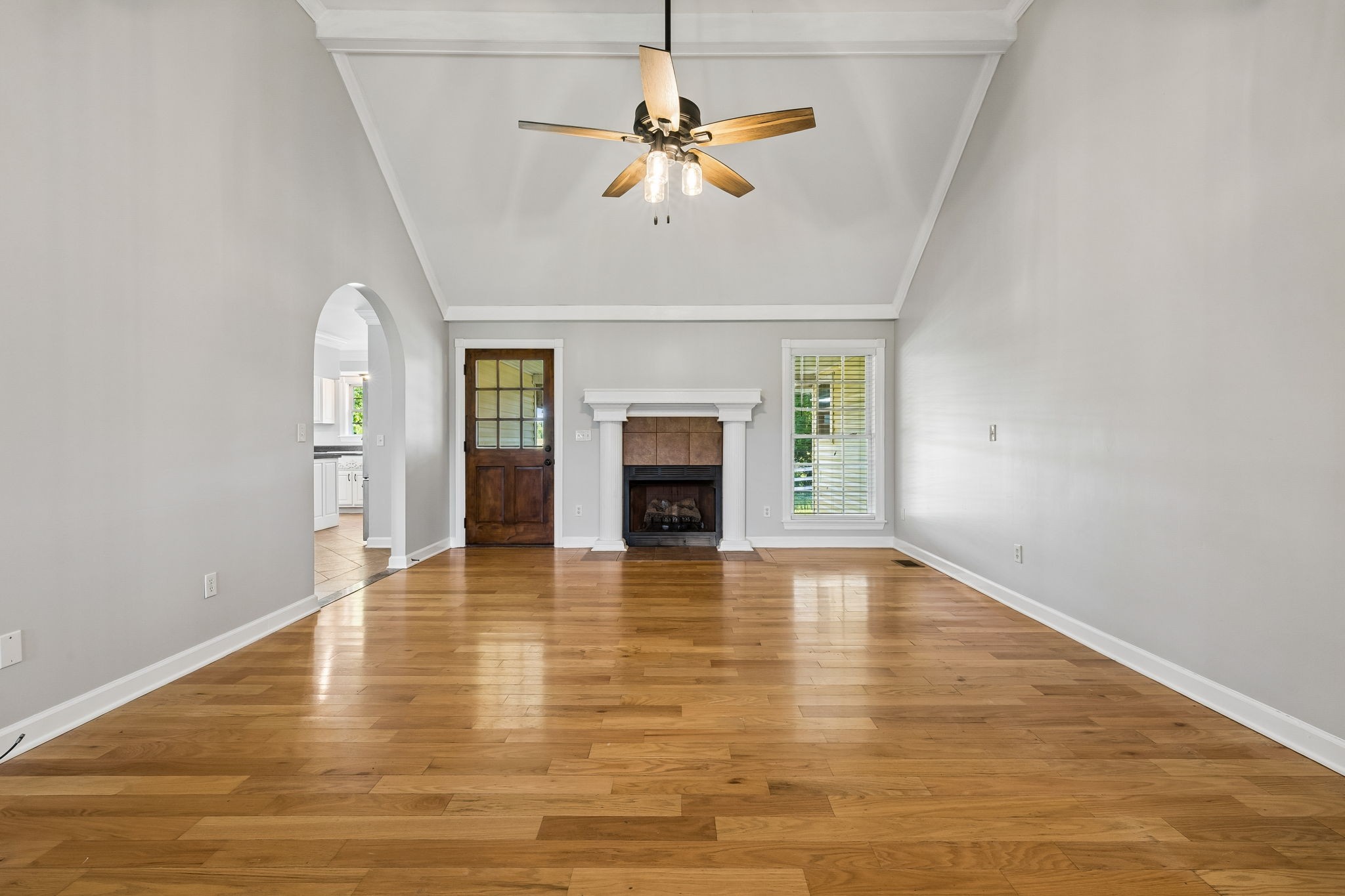 100 Heath Road Charlotte, TN 37036 - Photo 7 of 42 an empty room with chandelier fan and fireplace