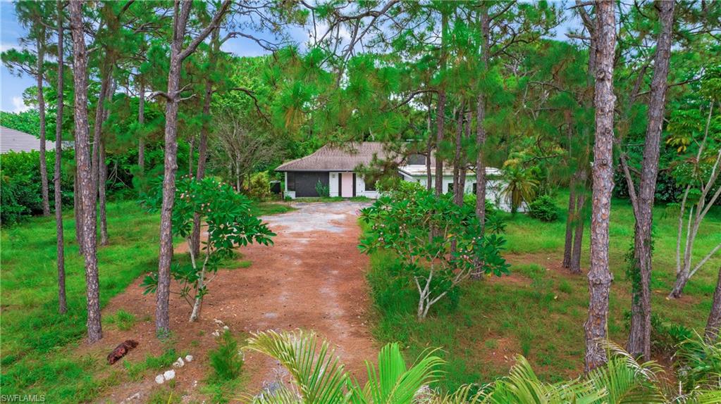 6640 Trail Boulevard Naples, FL 34108 - Photo 3 of 25 a view of a garden with plants