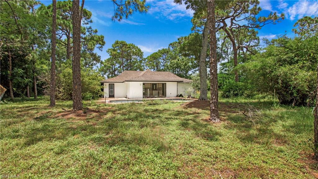 6640 Trail Boulevard Naples, FL 34108 - Photo 5 of 25 a house view with a garden space