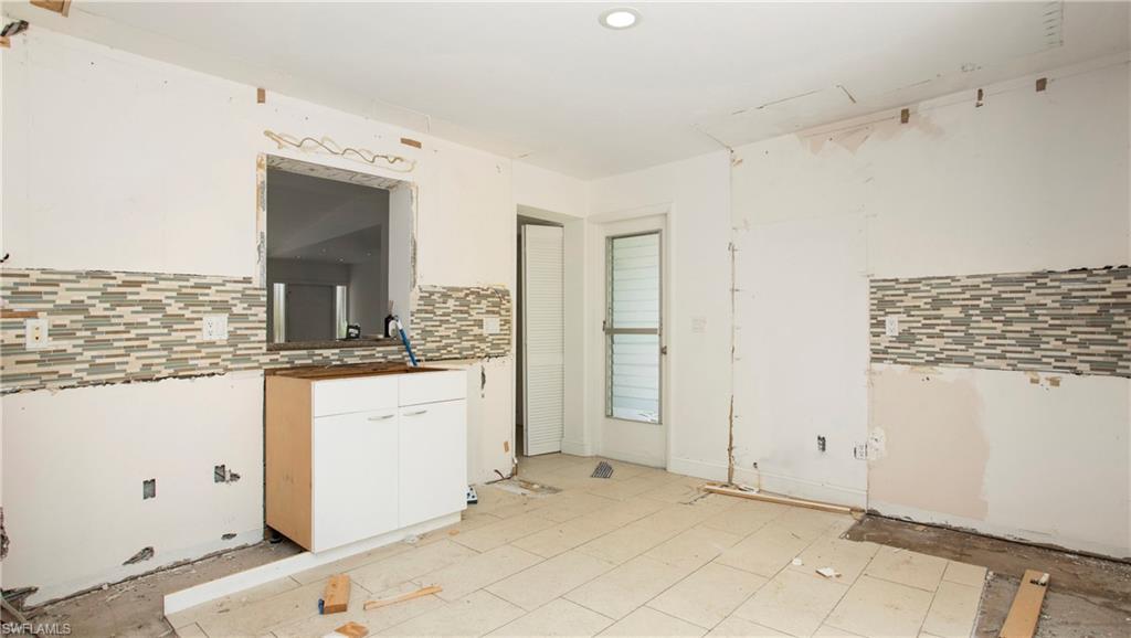 6640 Trail Boulevard Naples, FL 34108 - Photo 7 of 25 a bathroom with a sink and a mirror