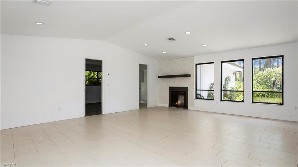 6640 Trail Boulevard Naples, FL 34108 - Photo 8 of 25 an empty room with floor to ceiling window and an empty room