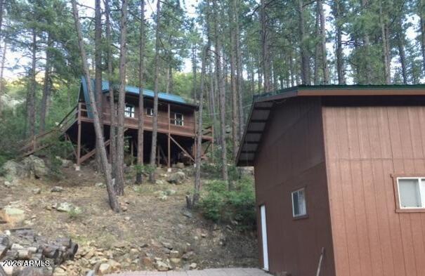 7345 Crown King Road Crown King, AZ 86343 - Photo 6 of 22 a view of a wooden house with a yard