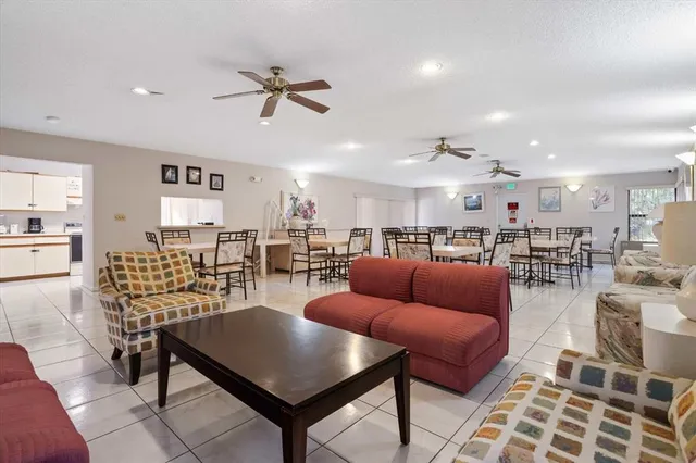 a living room with furniture kitchen view and a table