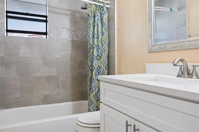 a bathroom with a sink a toilet and a bathtub