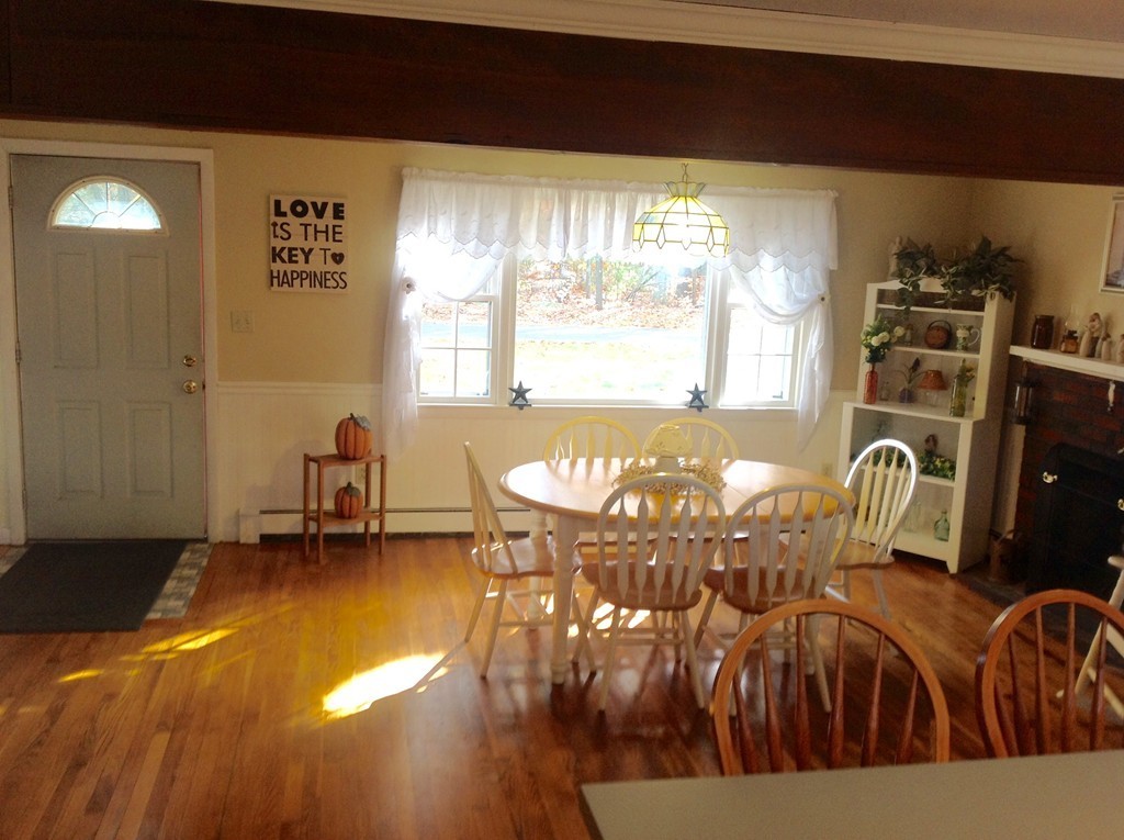 99 Keyes Road Westford, MA 01886 - Photo 7 of 20 a view of a dining room with furniture and wooden floor