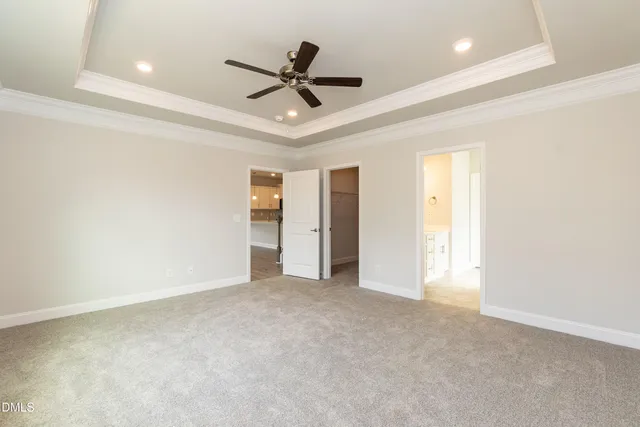 a view of an empty room and a ceiling fan
