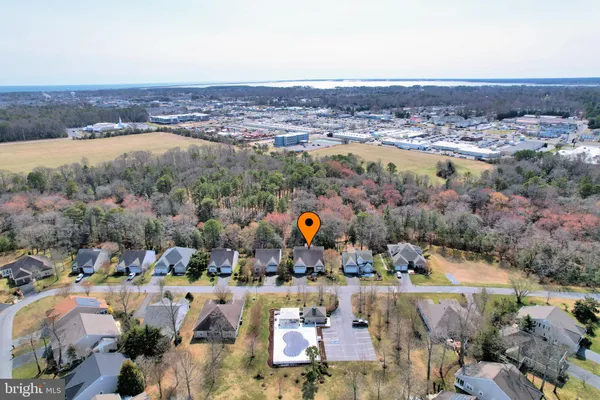 a front view of house with yard and trees around