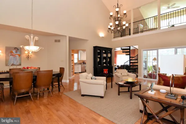 a living room with furniture chandelier and a table